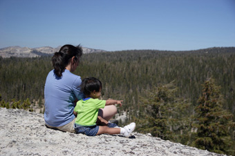 Natural Resource Protection - woman and child on a mountainside looking over a forest.