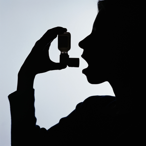Silhouette of a child with an asthma inhaler.