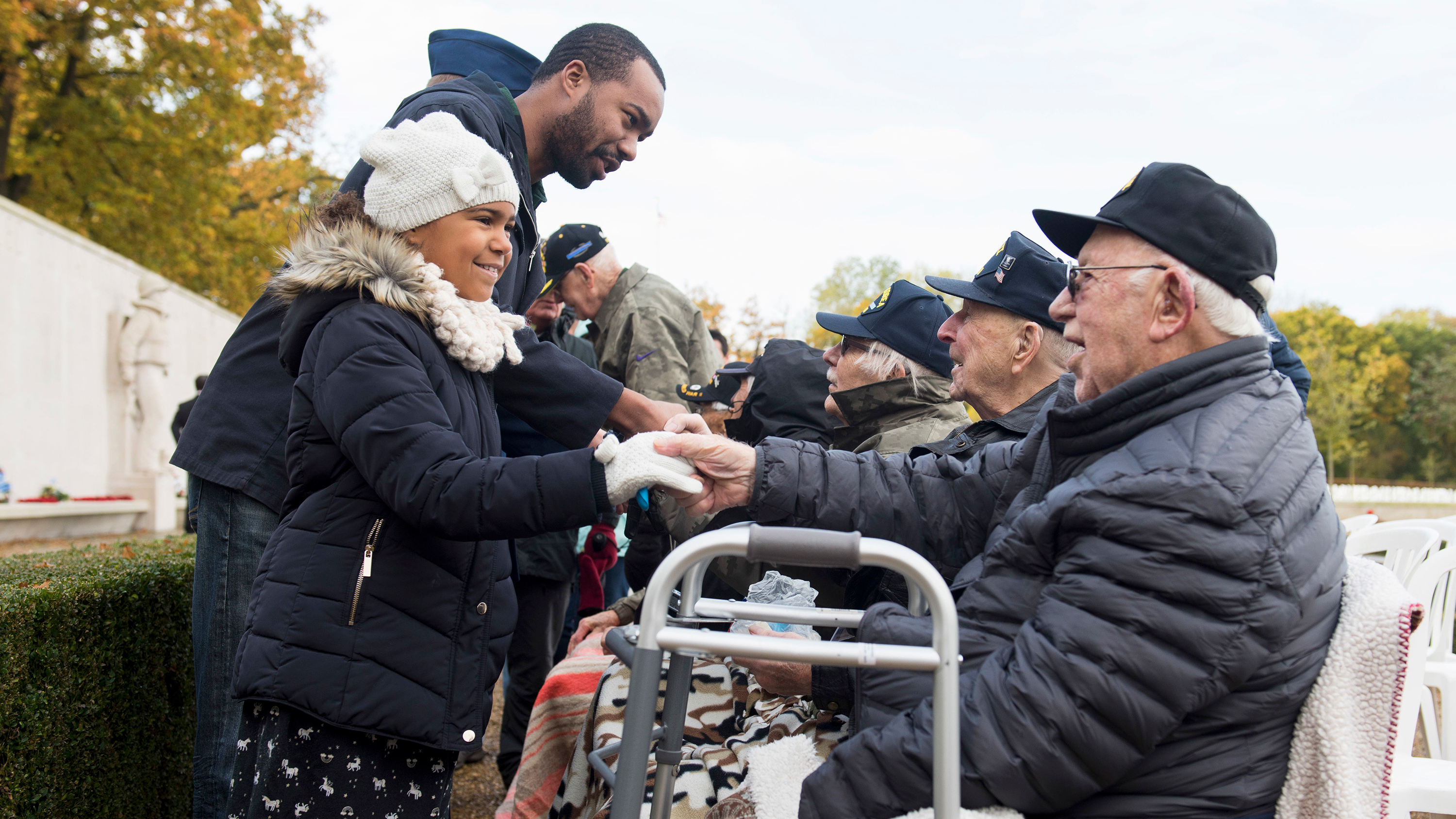 Man and girl honoring veterans