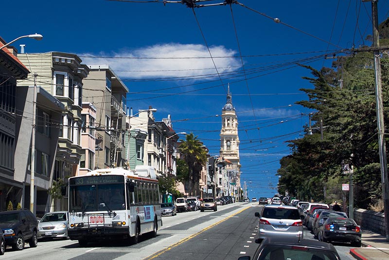 A street in San Francisco with cars parked at the curb